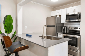 a kitchen with stainless steel appliances and a counter top